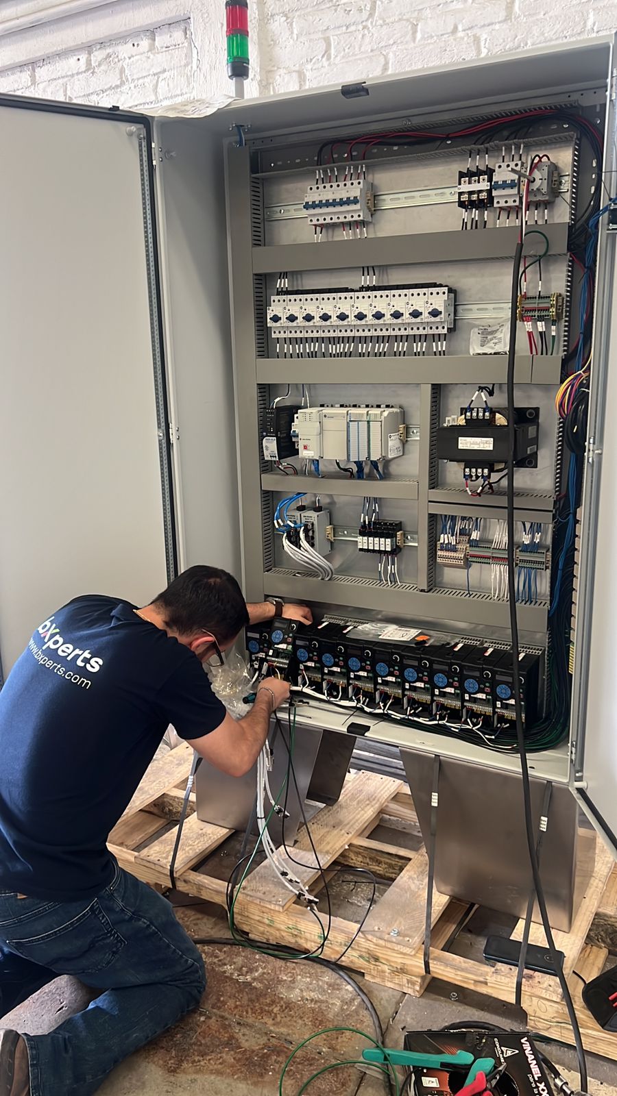 bXperts technician servicing an OEM equipment control panel